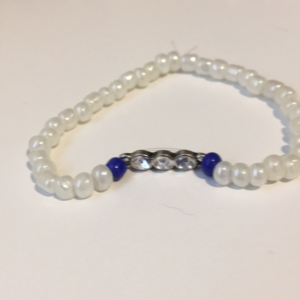 White beaded braclet with charm